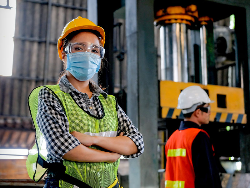 Warehouse Worker with Mask and Safety Vest on 