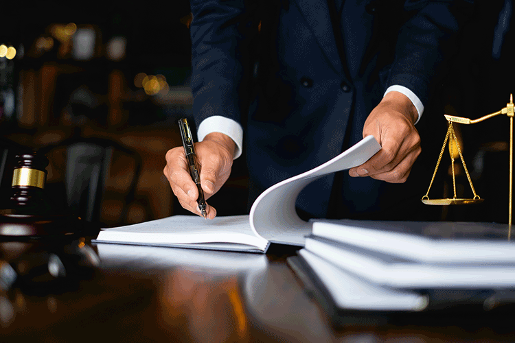 professional in legal setting signing paperwork with pen