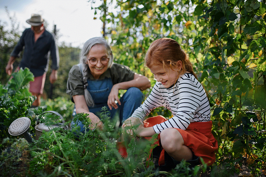 senior working in the garden with a child