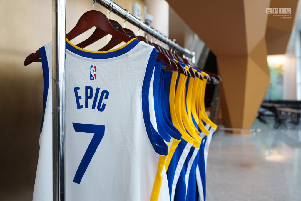 A row of basketball jerseys hanging on a rack, featuring a prominent jersey with the number 7 and the word 